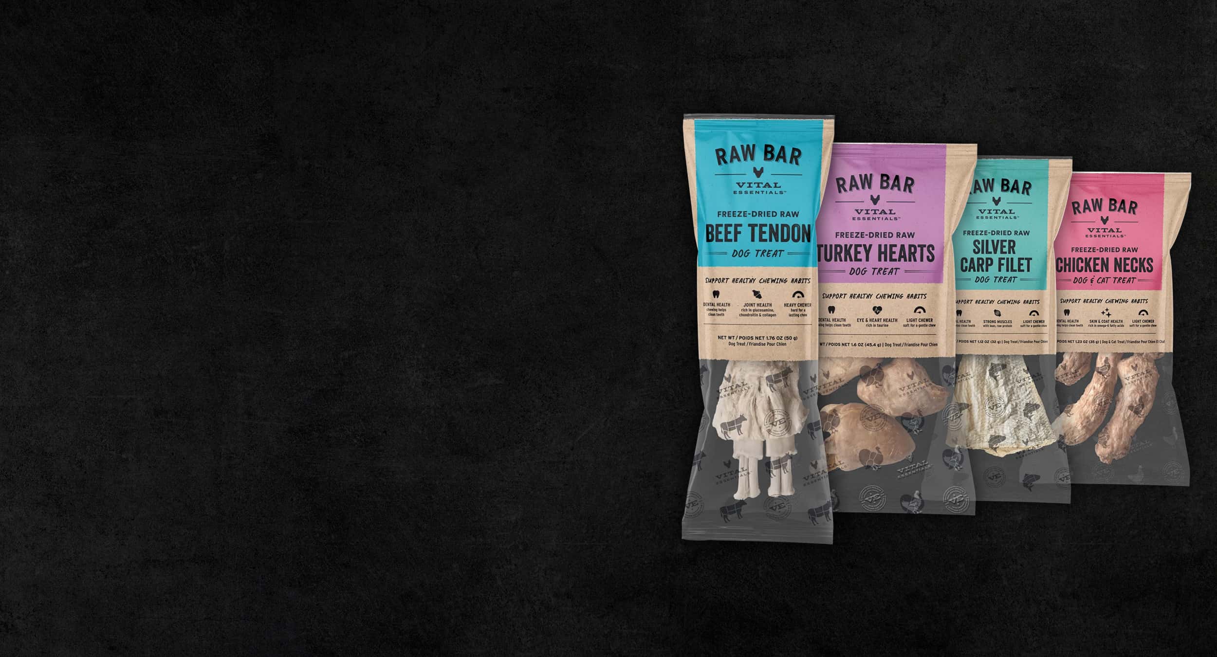 Four packages of RAW BAR pet treats against a dark background, featuring beef tendon, turkey hearts, silver carp filet, and chicken necks.