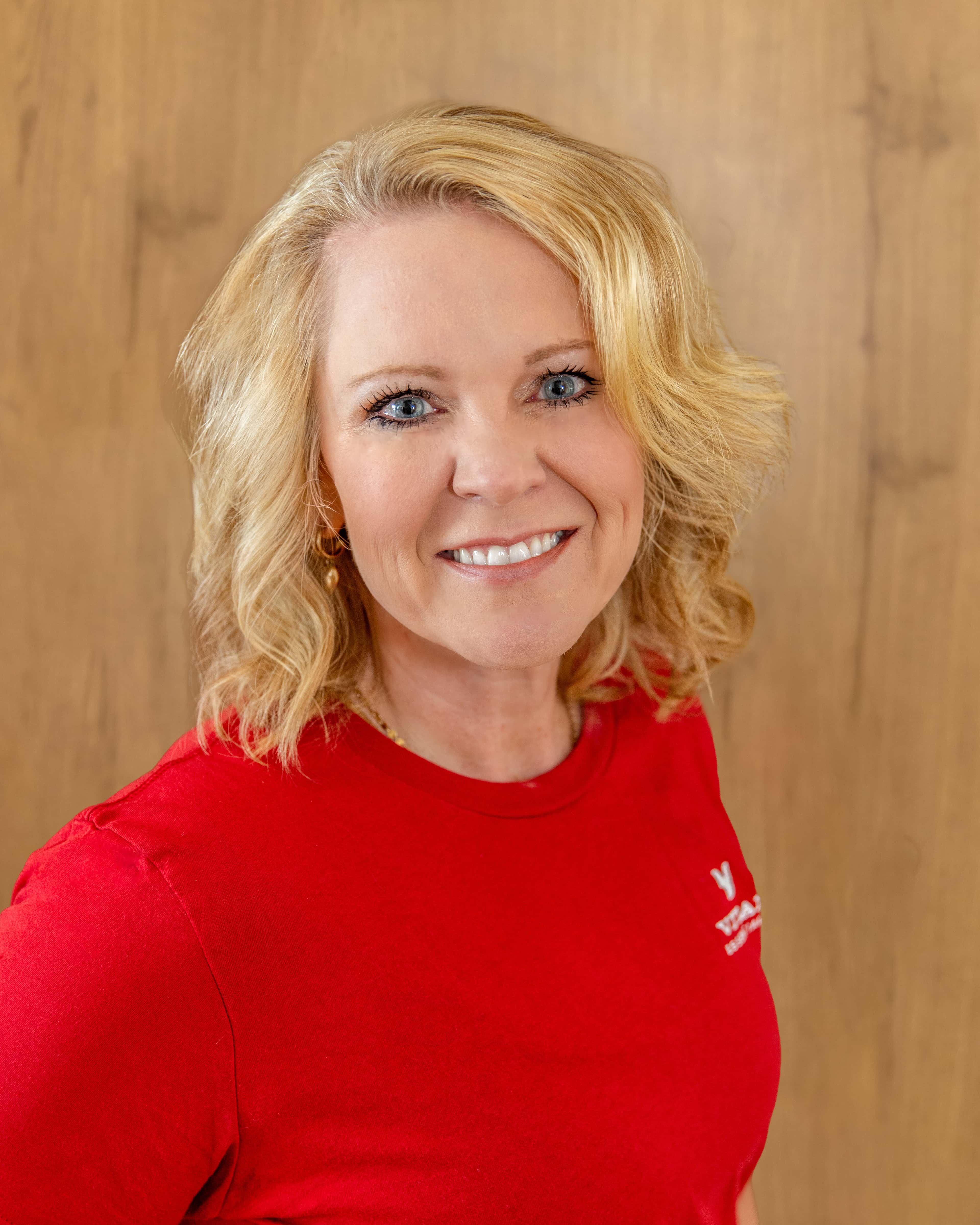 Headshot of Heather Govea, CEO, in red Vital Essentials shirt